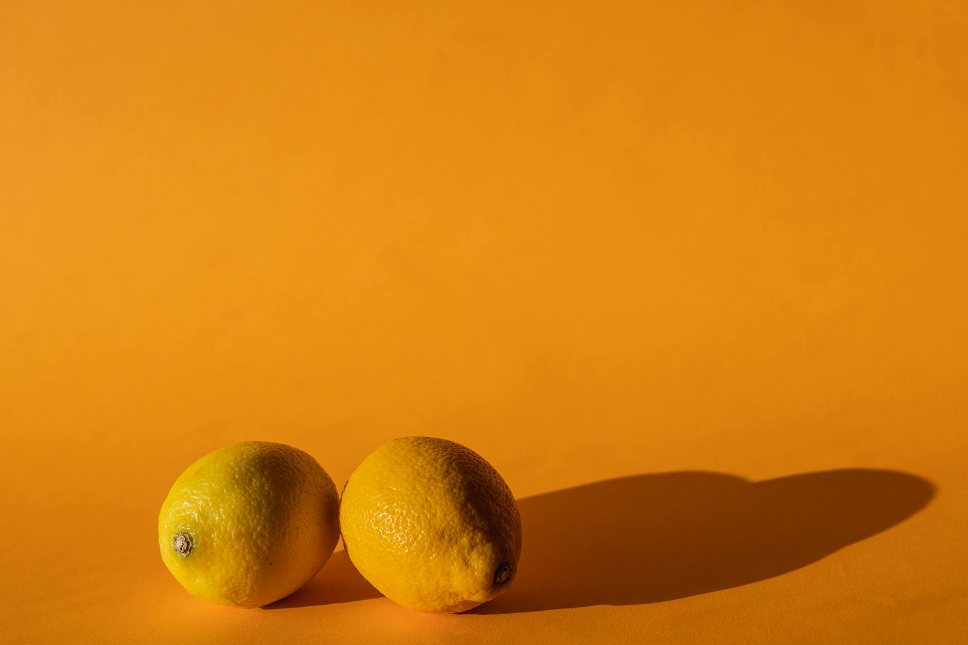 Fresh lemons on a bright yellow background symbolizing renewal and clarity